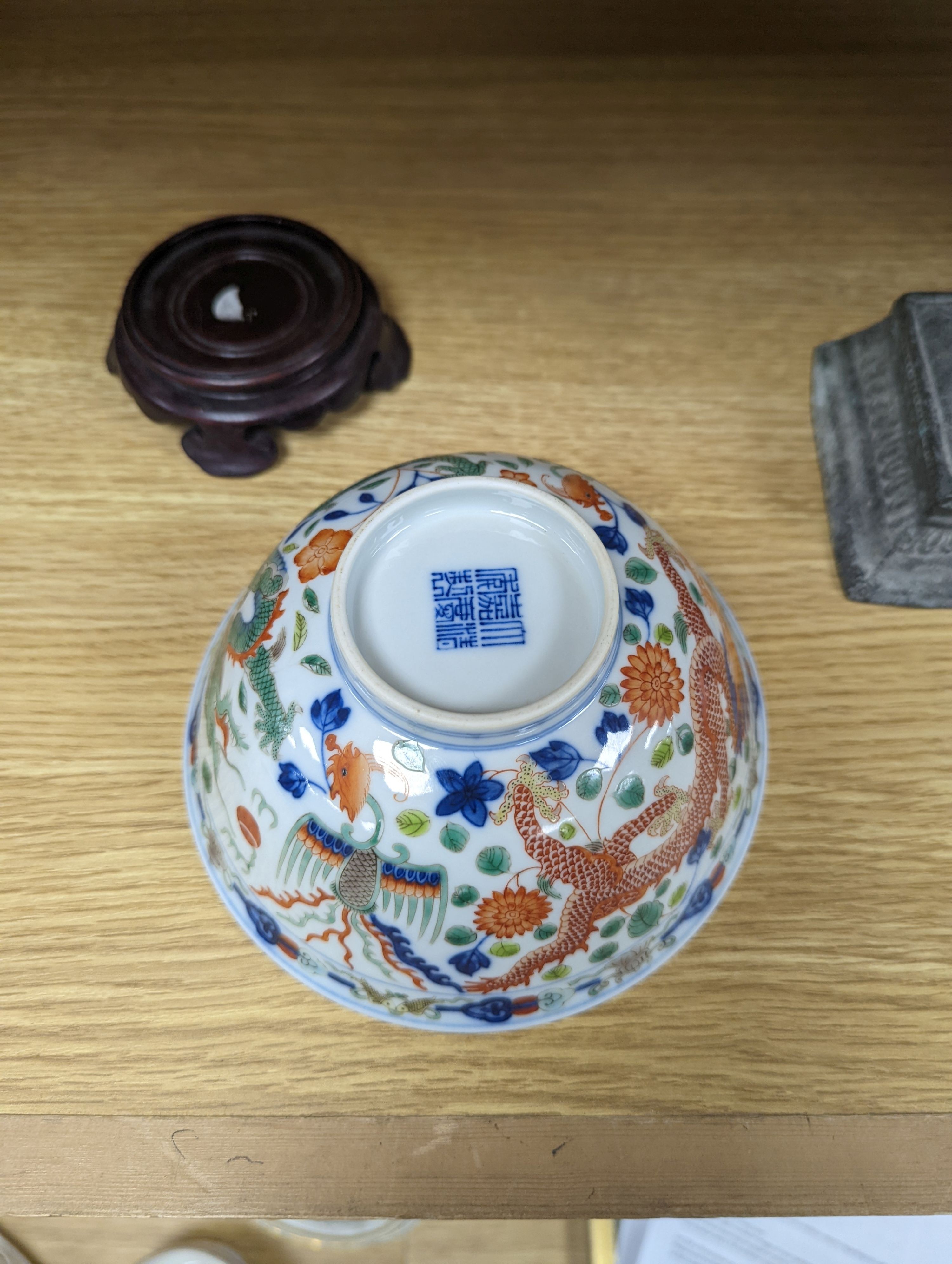 A Wucai bowl, dragon and flamingo pearl decoration, Jiaqing mark, on wood stand. 16cm diameter